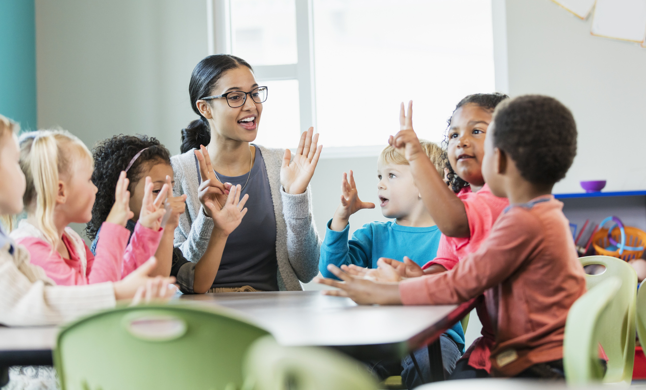 Preschool teacher and students in class
